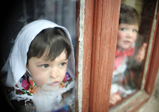 Gallery 14 January 2009: Vevcani, Macedonia: Children look out of a window during a pagan ritual