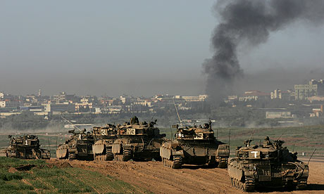 A column of Israeli tanks take up postion near the Gaza border