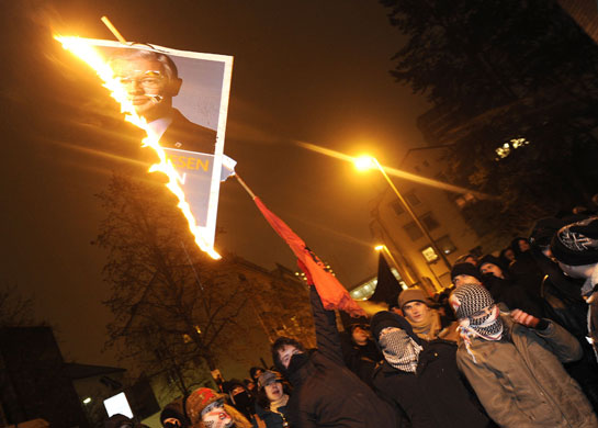 Gallery 24 hours in pictures : Left wing protestors burn a portrait of    Roland Koch 