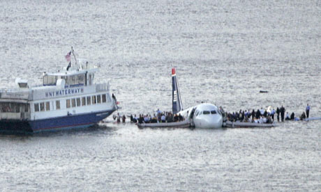 Passengers stand on the wings of a US Airways plane