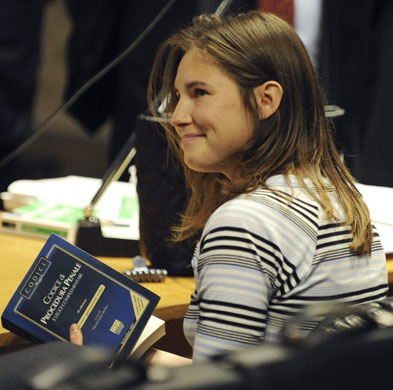 Gallery Meredith Kercher trial: Murder suspect Amanda Knox holds the Italian penal code book at her trial 