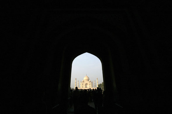 Gallery 24 hours in pictures: Tourists stand in front of the historic Taj Mahal in Agra