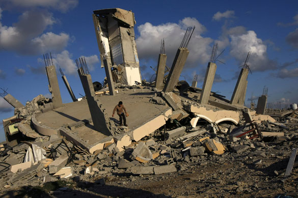 Gallery Withdrawal from Gaza: A Palestinian searches through the rubble in Jabalia