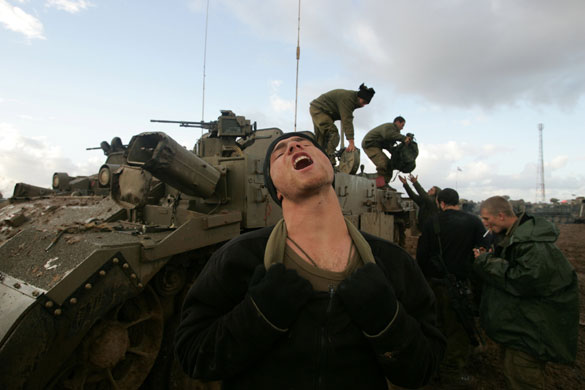 Gallery Withdrawal from Gaza: An Israeli soldier shouts after exiting Gaza on the Israel-Gaza border