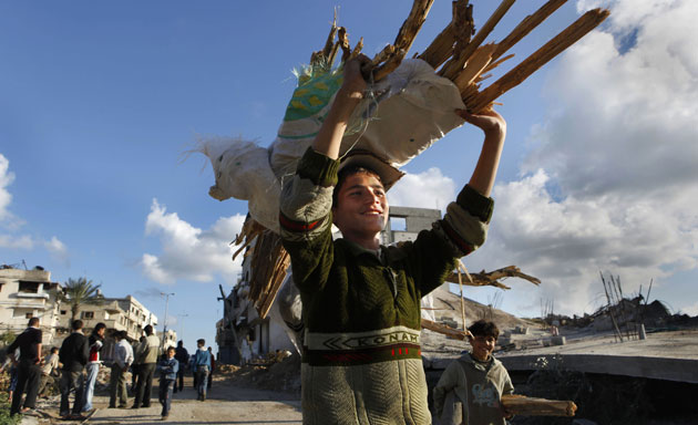 Gallery Withdrawal from Gaza : A Palestinian boy carries wood from destroyed houses to use as firewood