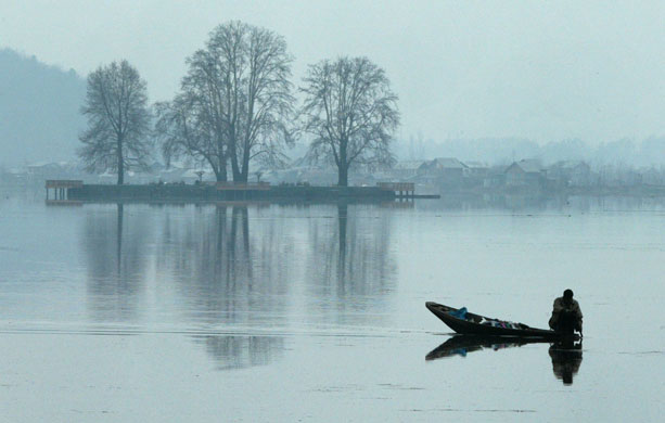 Gallery 24 hours in pictures:  Kashmiri paddles his boat through the morning mist on Dal Lake