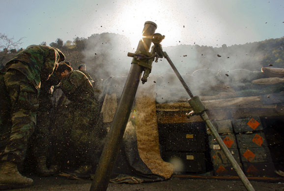 Gallery 24 hours in pictures: Afghan army soldiers fire a mortar 