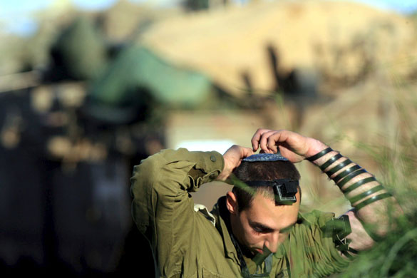 Gallery 24 hours in pictures: An Israeli soldier prays