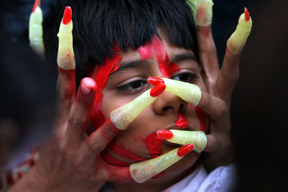 Gallery 24 hours in pictures: A protestor pretends to strangle a boy