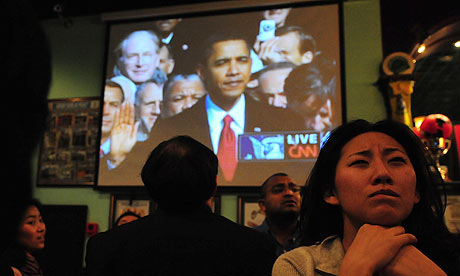 People in a Beijing bar watch the inauguration of the US president, Barack Obama