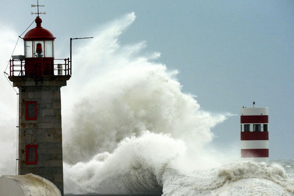 Gallery 21 January 2009: Porto, Portugal: A wave crashes into a lighthouse during a storm