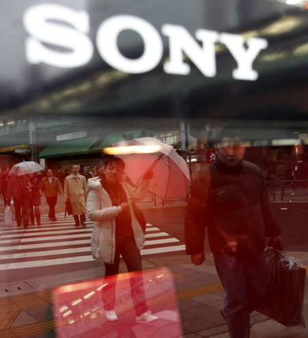 Gallery Business week: Pedestrians are reflected in a Sony window display