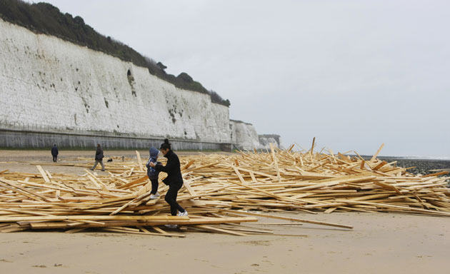 Gallery Timber galore: Local Ramsgate residents play on timber washed up on the beach