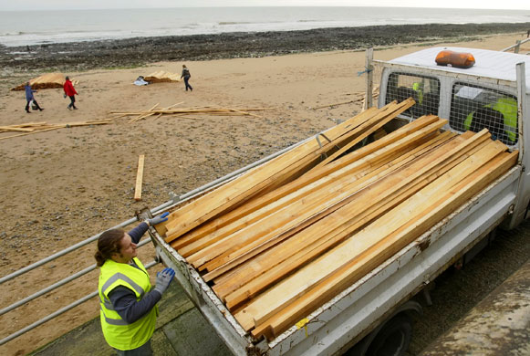 Gallery planks in Ramsgate: A man salvages a cargo of timber lost from the ship Sinegorsk