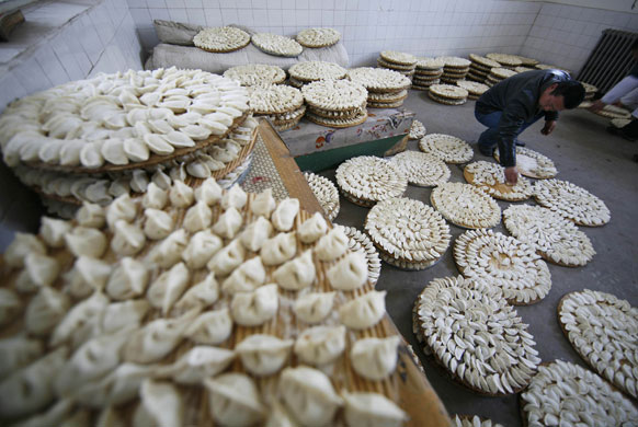 Gallery World Chinese New Year:  man sorts dumplings