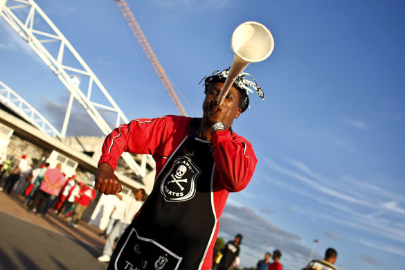 Gallery 24 hours in pictures: A fan of Orlando Pirates dances outside the Athlone stadium