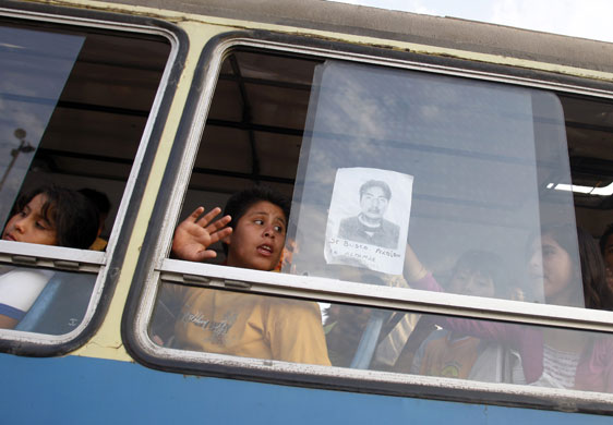 Gallery 24 hours in pictures: A relative of one of six missing fishermen holds his picture in Peru 