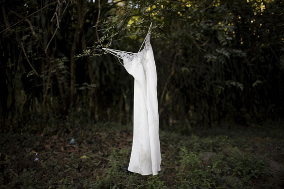 Gallery 24 hours in pictures: A dress hangs from a tree branch next to a road in Guatemala