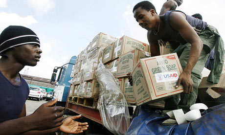 Aid workers offload supplies for people in Harare