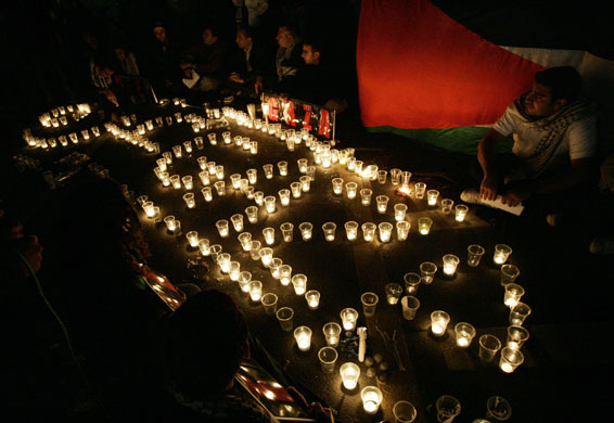Gallery Israeli troops enter Gaza: Protesters light candles during a demo in Dubai