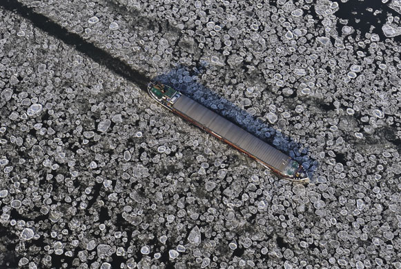 Gallery Eyewitness: A barge cuts a channel through ice boulders ﬂoating on the river Elbe