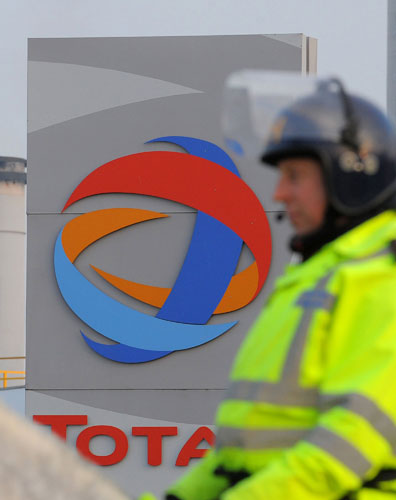 Gallery Oil refineries strike: Police watch protesters outside the Total Lindsey oil refinery. 