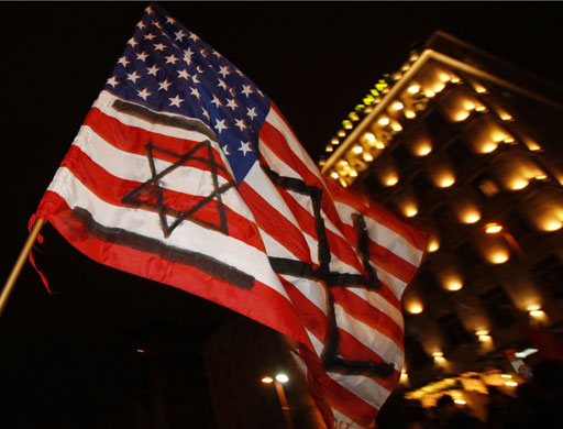 Gallery Protests against Israel: A United States flag is held during protest in Rome