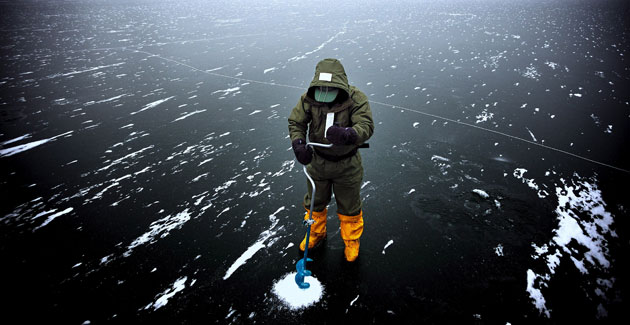 Gallery 24 hours in pictures: An ice fisher breaks the ice to fish on a frozen lake