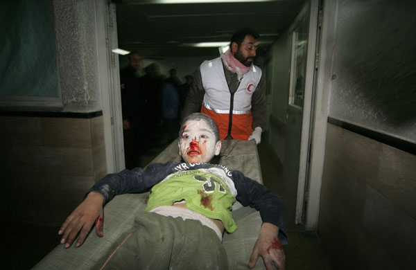 Gallery gaza conflict: Palestinian medics carry a wounded boy into a hospital in Gaza City