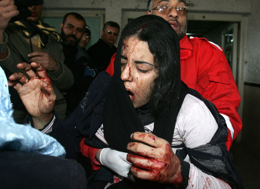 Gallery Gaza: 4 January: A wounded Palestinian girl is carried into a hospital in Gaza