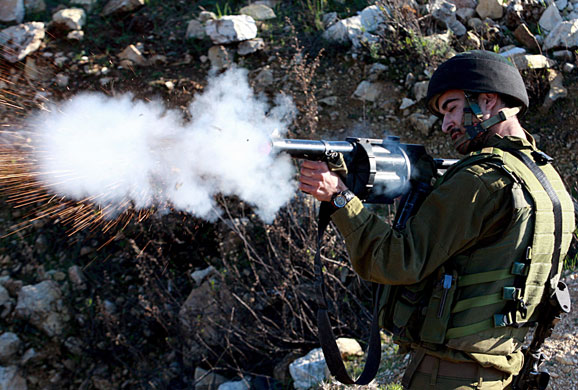 Gallery Gaza: Israeli soldier fires tear gas during clashes with Palestinian protesters