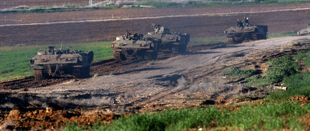 Gallery Gaza: A line of Israeli armoured personnel carriers (APCs)