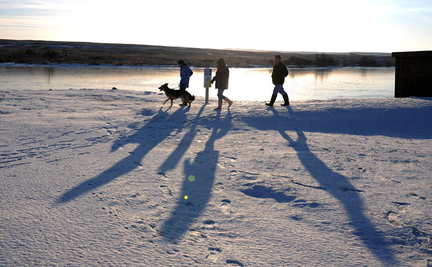 Gallery snow: North Yorkshire: Walkers beside a frozen scaling dam