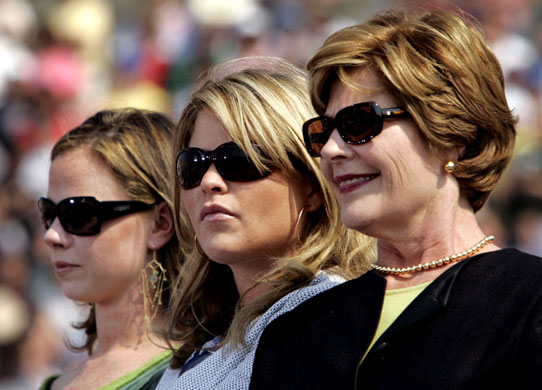 Gallery President George W Bush: First lady and daughters sit together at a rally in Pennsylvania