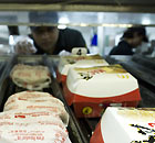 Hamburgers await customers on a rack in McDonald's fast food restaurant