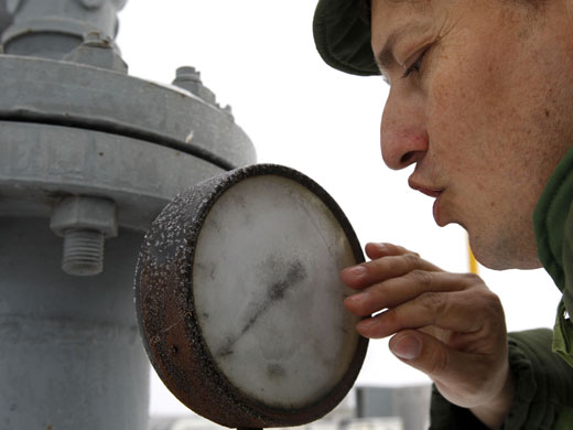 Gallery Russia Ukraine gas row: An employee of a Slovak gas company clears the glass of a gauge 