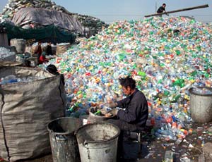 Migrant workers sort plastic waste for recycling