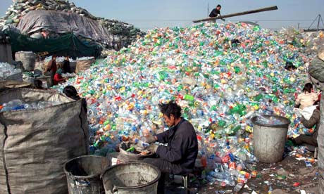Migrant workers sort the plastic waste for recycling