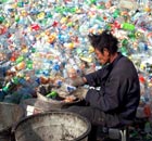 Migrant workers sort the plastic waste for recycling