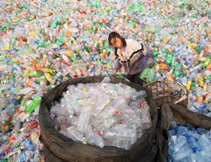 A migrant worker recycles plastic bottles in Beijing