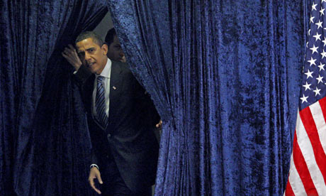 U.S. President-elect Obama steps out from behind a curtain  