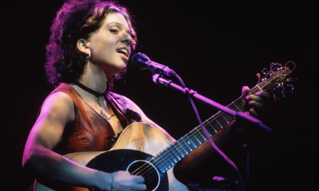 Ani DiFranco singing and playing guitar