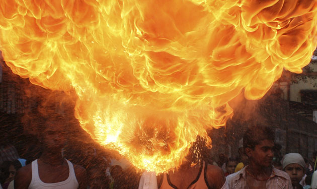Gallery 24 hours in pictures: Aboy performs firebreathing during an Ashura procession in Ahmedabad