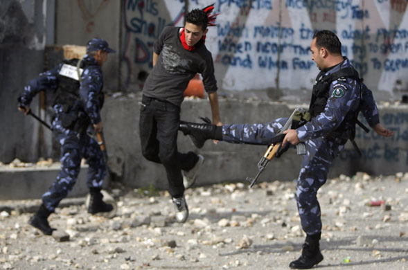 Gallery 24 hours in pictures: Member of Palestinian security forces kicks a Palestinian protestor 
