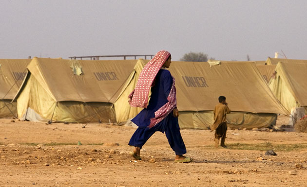 Gallery Children in Pakistan: A young girl from Bajur, Pakistan, walks through a refugee camp