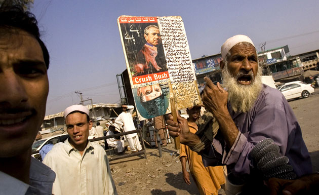 Gallery Children in Pakistan: An elderly man at the Khyber tribal border carries a placard of George Bush