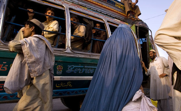 Gallery Children in Pakistan: Pakistanis and Afghans board a bus leaving for the tribal areas