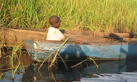 A child in a fishing boat in Merok parish, Katine. Children spend much of their time fishing instead of studying because of the drought and food shortages
