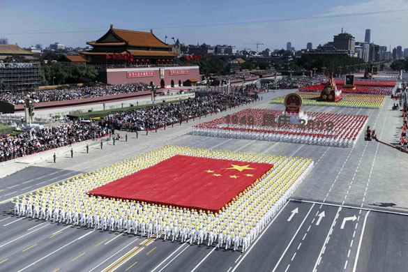 china anniversary : People in formation carry the national flag at china anniversary 
