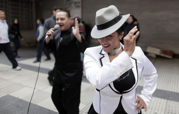 24 hours in pictures: Buenos Aires, Argentina: A tango dancer smiles during a street performance
